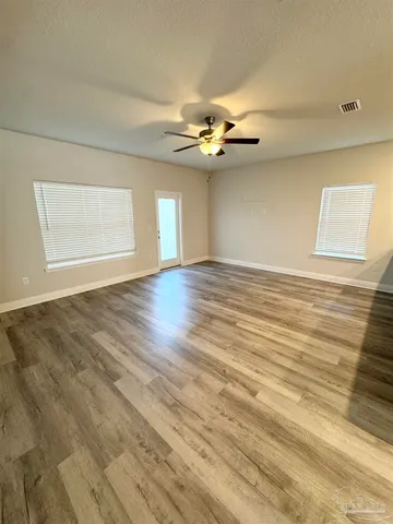 a view of an empty room with windows