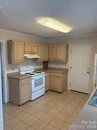 a kitchen with a stove top oven sink and cabinets