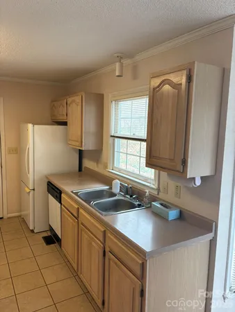 a kitchen with stainless steel appliances granite countertop a sink and a refrigerator
