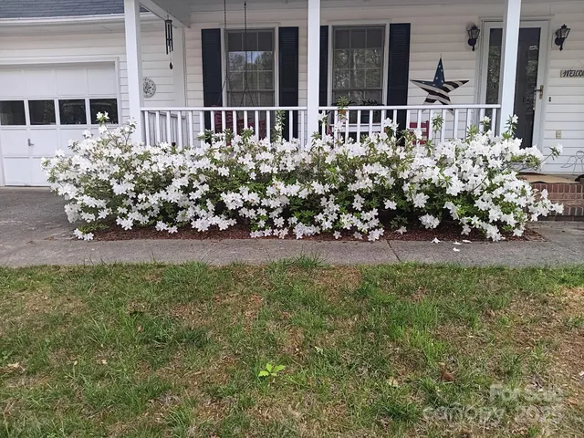 a view of a house with wooden fence