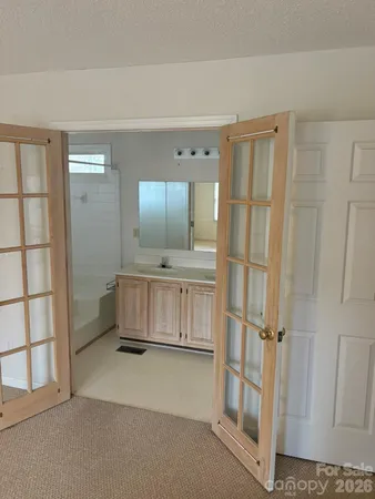 a view of an empty room with cabinet and stairs