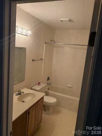 a bathroom with a double vanity sink toilet mirror and shower
