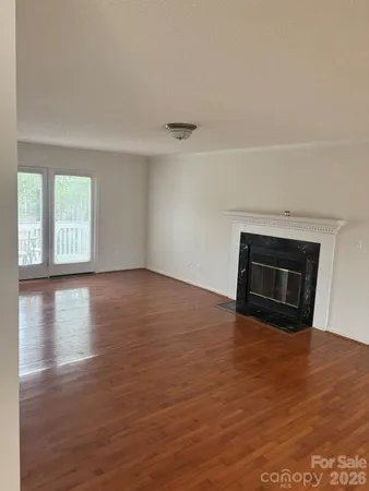 wooden floor in an empty room with a fireplace
