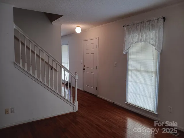 a view of an entryway with wooden floor