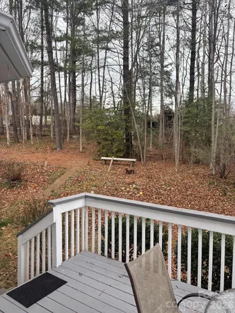 a view of a wooden deck and trees
