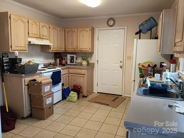 a kitchen with a sink a stove and cabinets