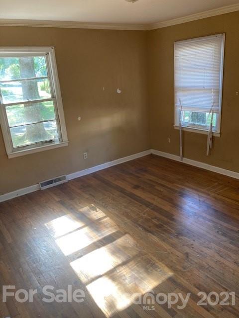 302 Lydia Street Monroe, NC 28110 - Photo 12 of 14 an empty room with wooden floor and windows