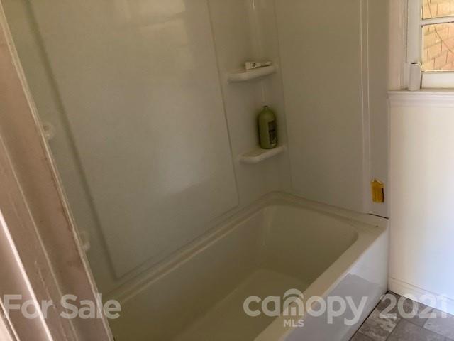 302 Lydia Street Monroe, NC 28110 - Photo 14 of 14 a bathroom with a bath tub