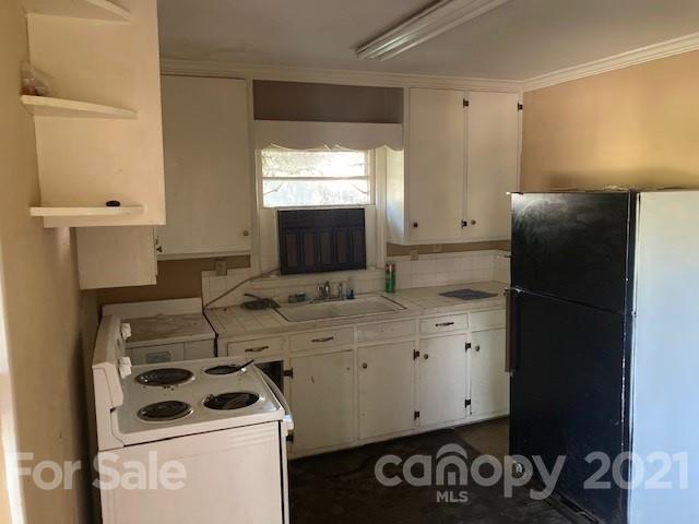 302 Lydia Street Monroe, NC 28110 - Photo 3 of 14 a bathroom with a sink and a washing machine