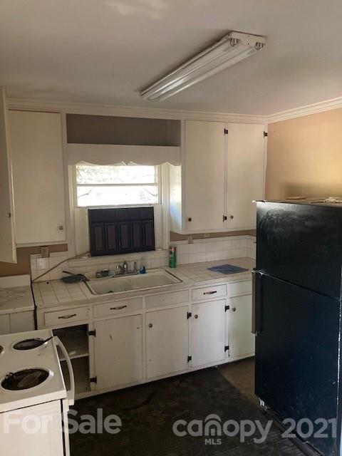 302 Lydia Street Monroe, NC 28110 - Photo 4 of 14 a kitchen with a stove and a microwave