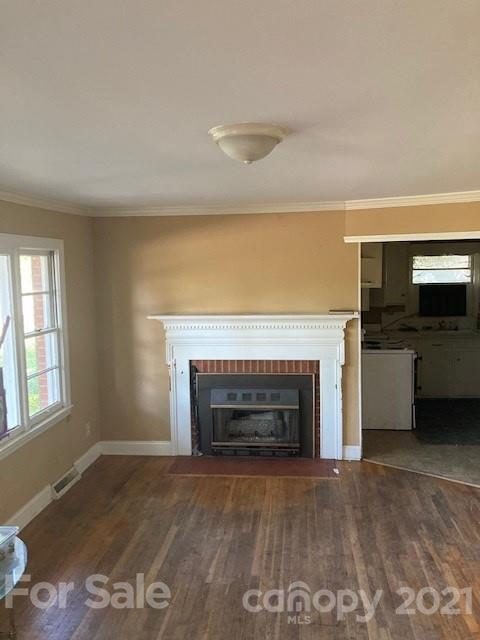 302 Lydia Street Monroe, NC 28110 - Photo 6 of 14 an empty room with fireplace and windows