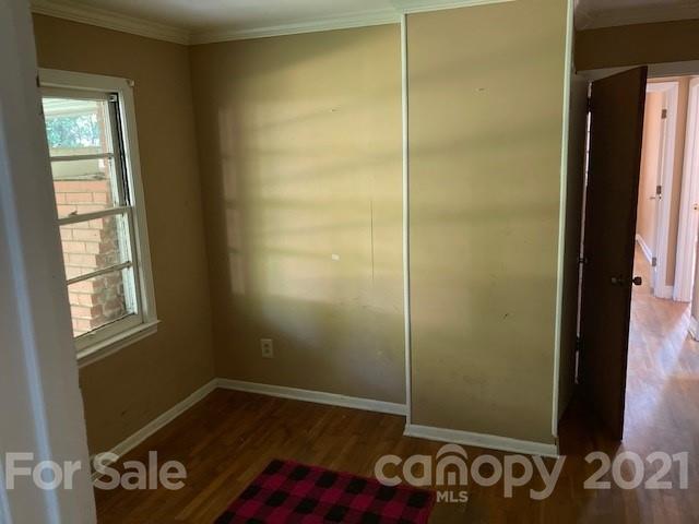 302 Lydia Street Monroe, NC 28110 - Photo 10 of 14 a view of an empty room with window and wooden floor