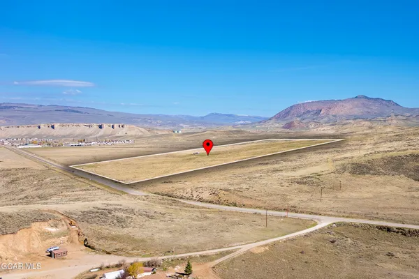 a white house with a yard and ocean view