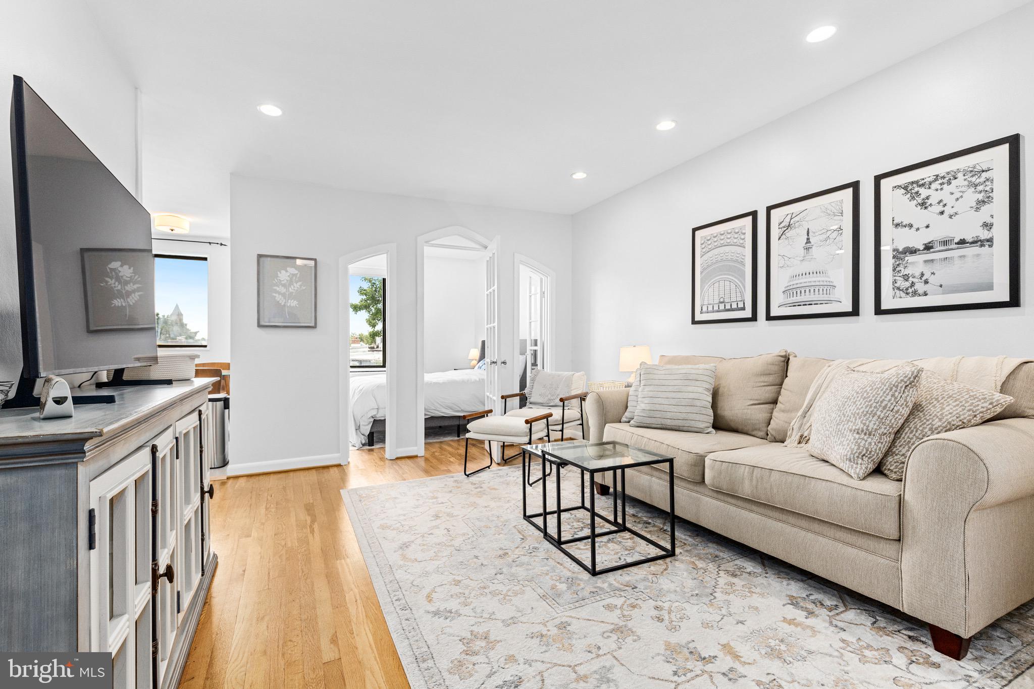 305 C Street Northeast, Unit 410 Washington, DC 20002 - Photo 1 of 15 a living room with furniture and a flat screen tv