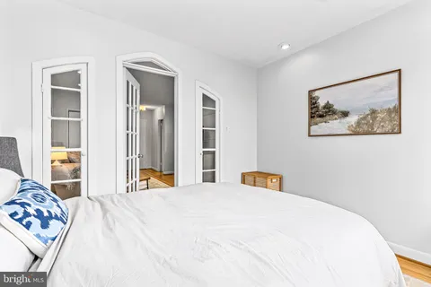 a bedroom with a bed and a large mirror