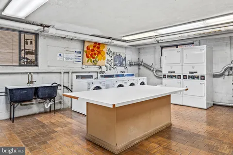 a view of living room with stainless steel appliances kitchen island furniture and a fireplace