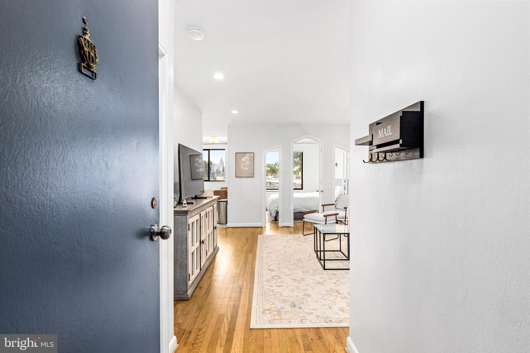 305 C Street Northeast, Unit 410 Washington, DC 20002 - Photo 3 of 15 a living room with furniture and a flat screen tv