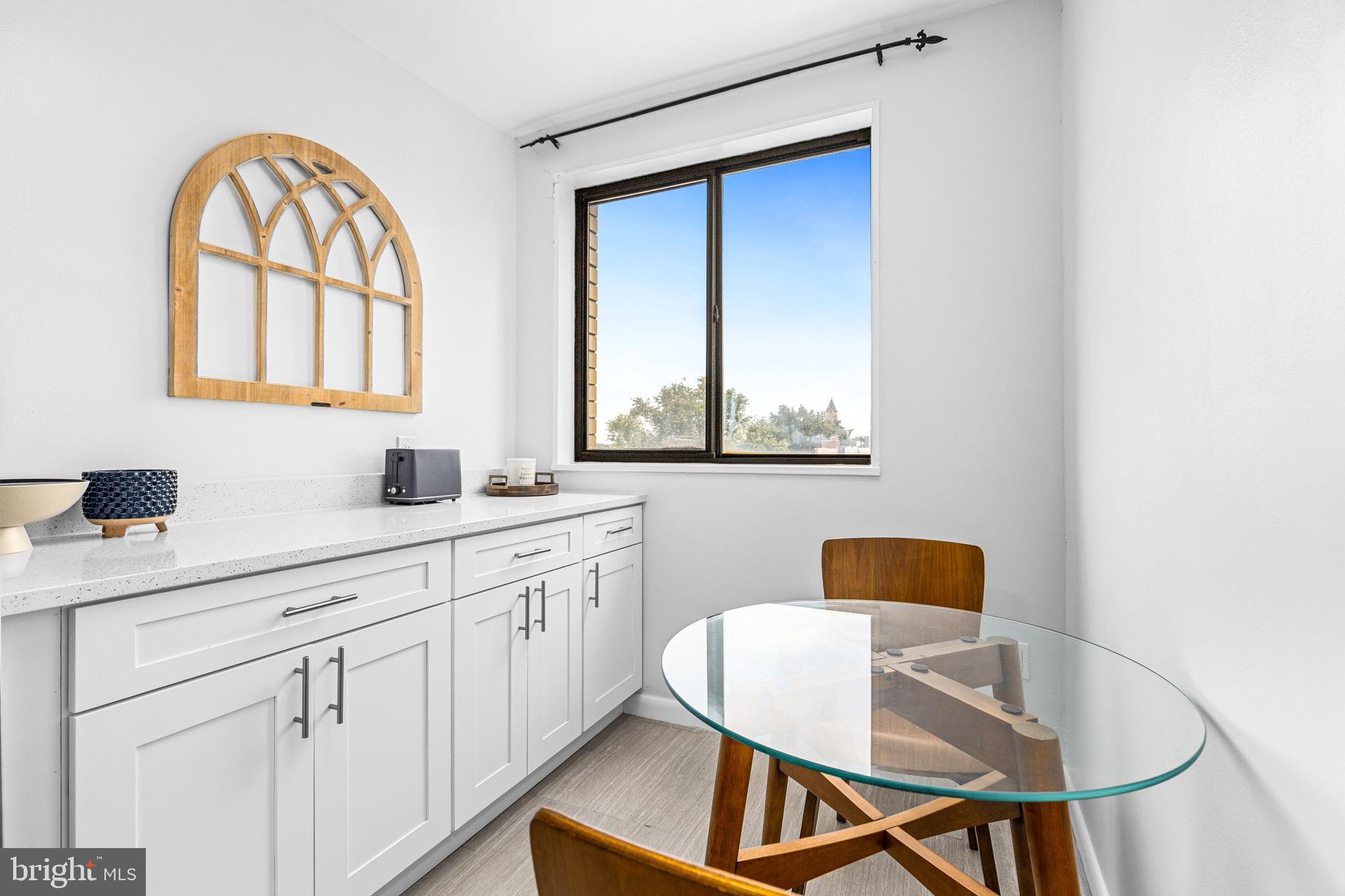 305 C Street Northeast, Unit 410 Washington, DC 20002 - Photo 8 of 15 a kitchen with a sink cabinets and a window