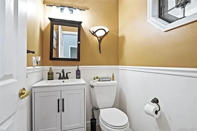 a living room with furniture a bookshelf and a window