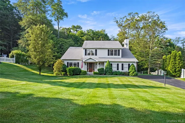 a front view of a house with a big yard