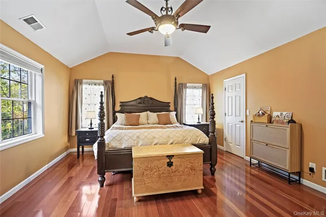 a bedroom with a bed and a large window with a flat screen tv