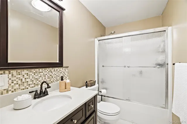 a bedroom that has a bed and a desk in it with a large window