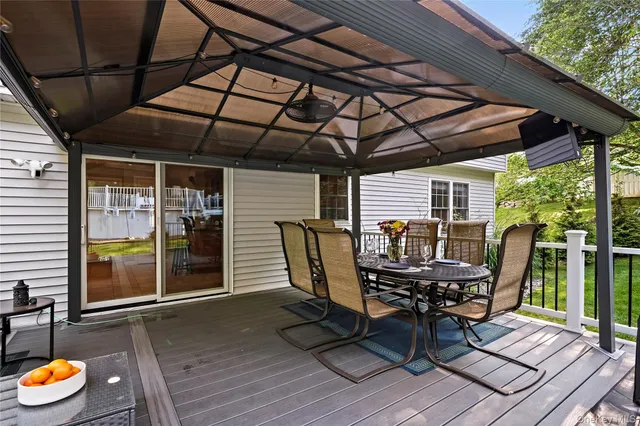 a backyard of a house with barbeque oven table and chairs