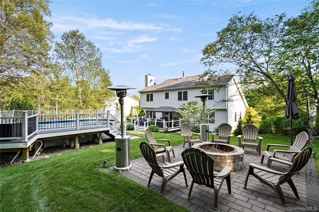 a view of a roof deck with table and chairs with wooden floor and fence