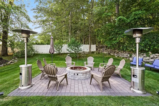 a view of a chair and table in backyard of the house