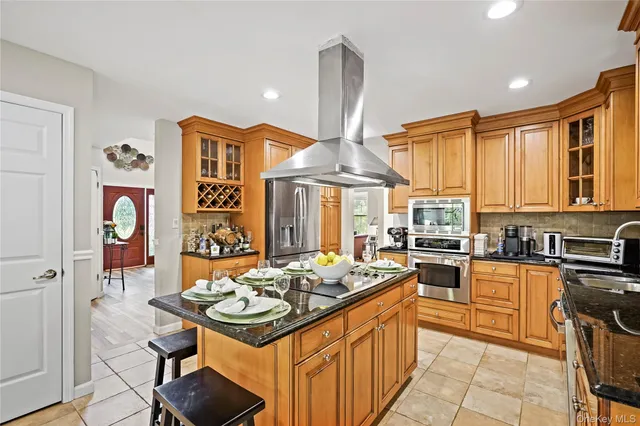 a kitchen with stainless steel appliances a stove a sink dishwasher and cabinets with wooden floor