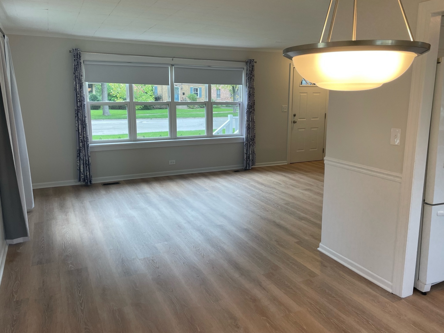 977 Spring Road Elmhurst, IL 60126 - Photo 3 of 13 an empty room with wooden floor and windows