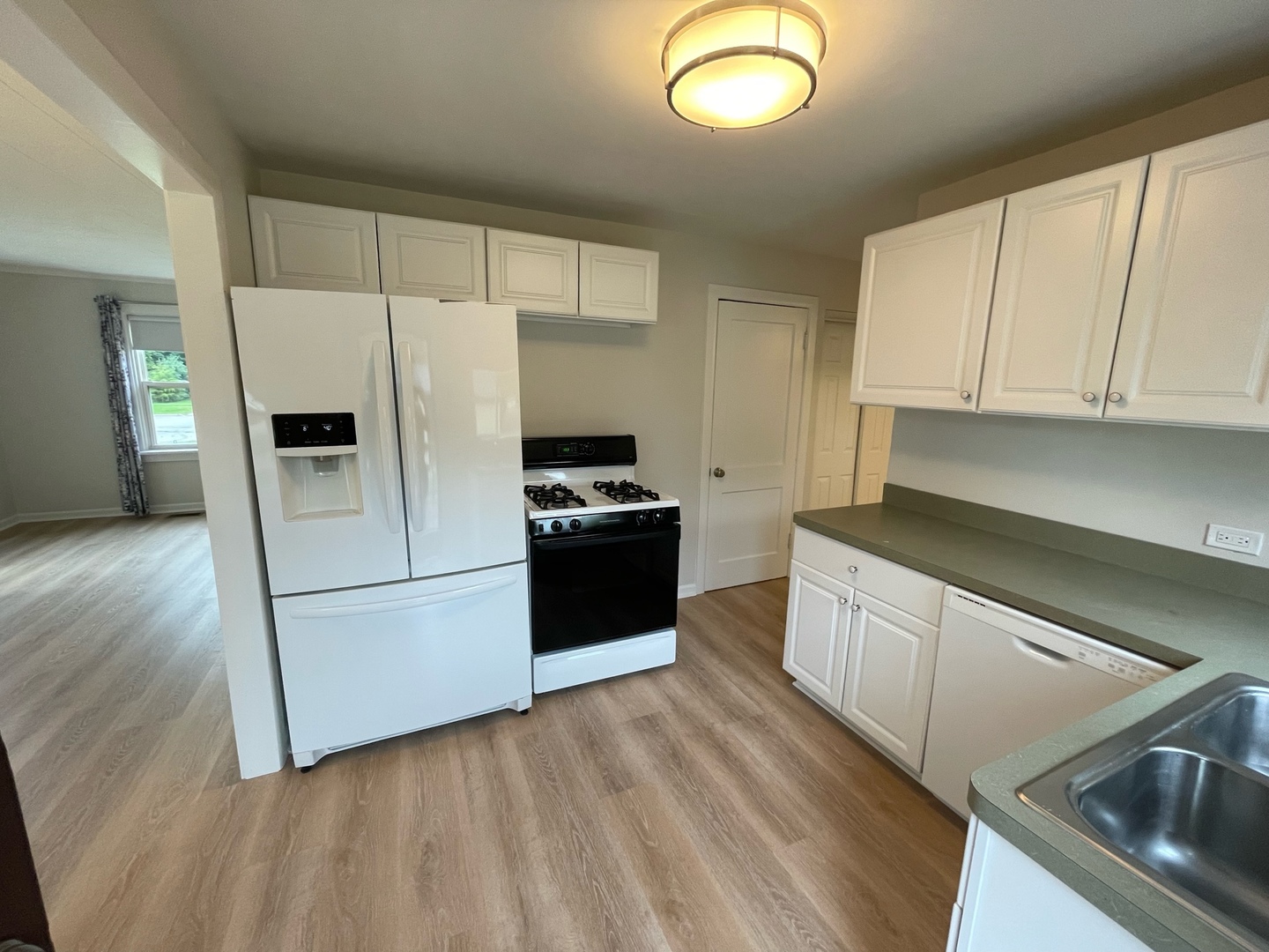 977 Spring Road Elmhurst, IL 60126 - Photo 4 of 13 a kitchen with granite countertop a refrigerator and a stove top oven