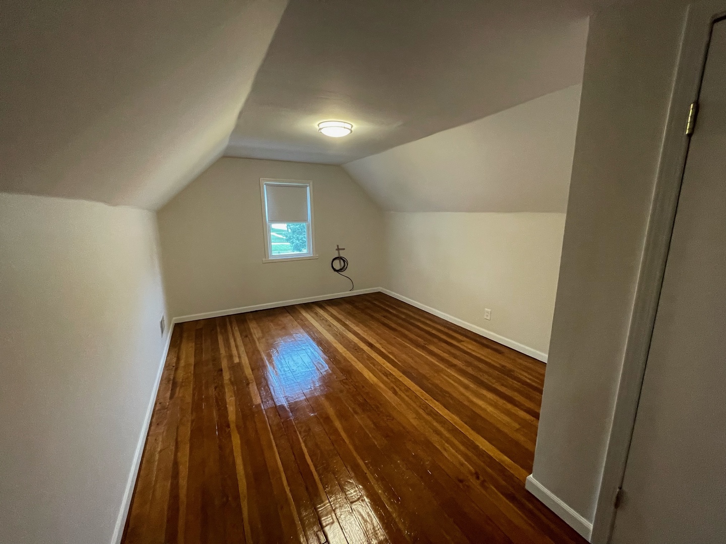 977 Spring Road Elmhurst, IL 60126 - Photo 7 of 13 an empty room with wooden floor and windows