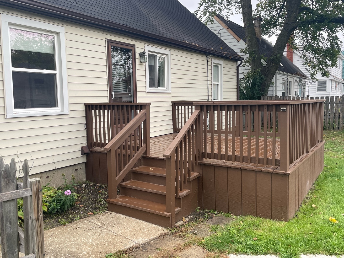 977 Spring Road Elmhurst, IL 60126 - Photo 9 of 13 a view of a house with wooden fence and a floor to ceiling window