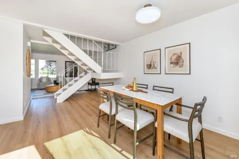 a view of a livingroom with furniture and hardwood floor