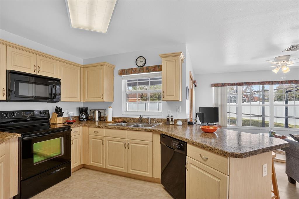 4995 Brook Road Kissimmee, FL 34758 - Photo 11 of 46 a kitchen with a sink stove and microwave