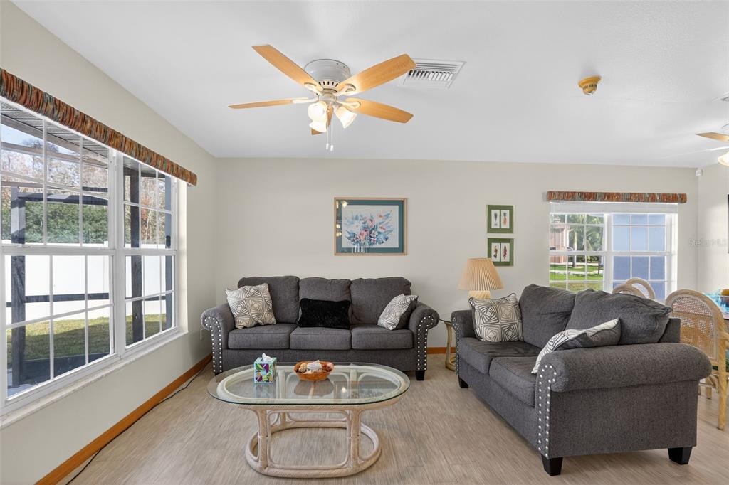 4995 Brook Road Kissimmee, FL 34758 - Photo 12 of 46 a living room with furniture a large window and a table