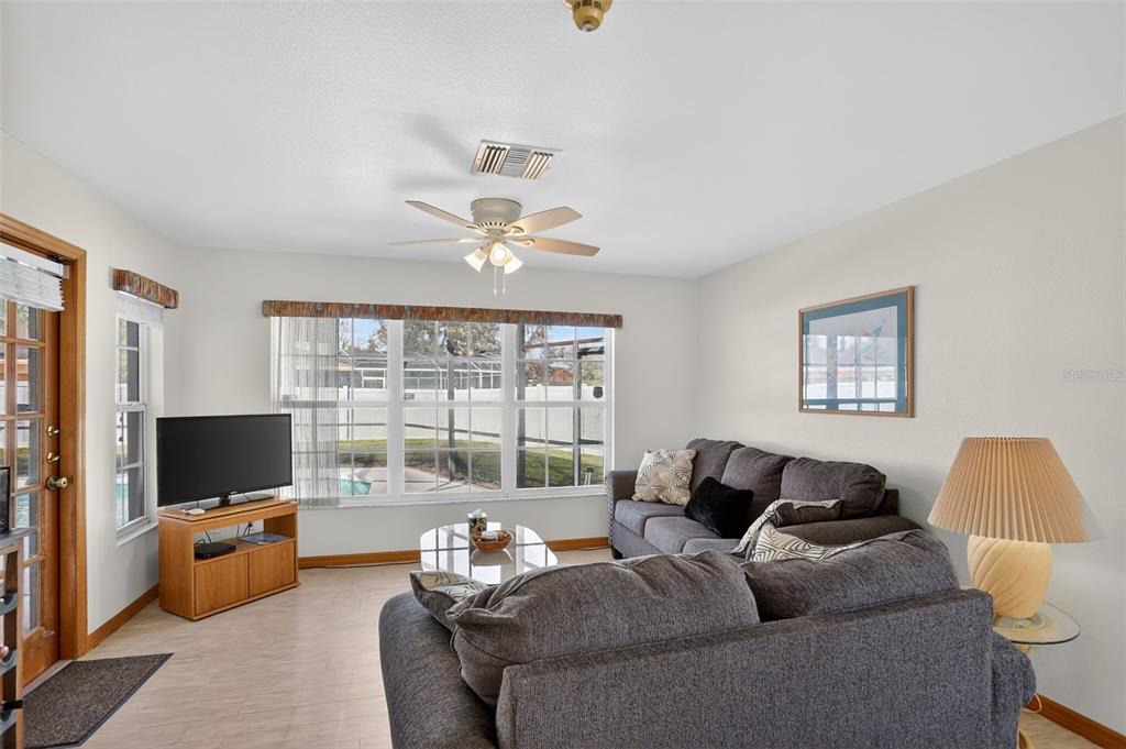 4995 Brook Road Kissimmee, FL 34758 - Photo 13 of 46 a living room with furniture and a flat screen tv