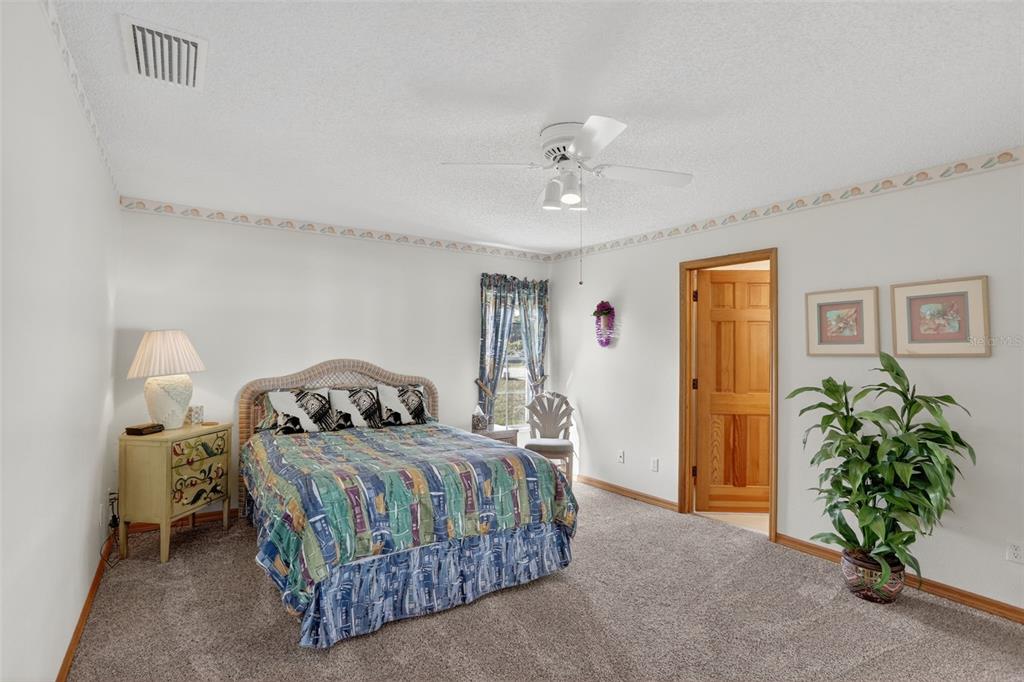 4995 Brook Road Kissimmee, FL 34758 - Photo 14 of 46 a bedroom with a bed and a chandelier