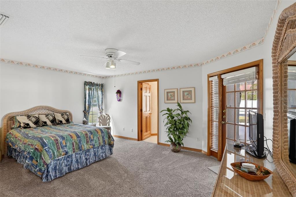 4995 Brook Road Kissimmee, FL 34758 - Photo 15 of 46 a bedroom with a bed and ceiling fan