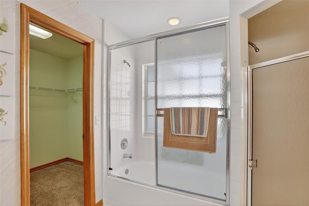 4995 Brook Road Kissimmee, FL 34758 - Photo 18 of 46 a bathroom with a glass shower door