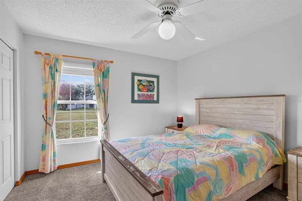 4995 Brook Road Kissimmee, FL 34758 - Photo 19 of 46 a bedroom with a bed and a window
