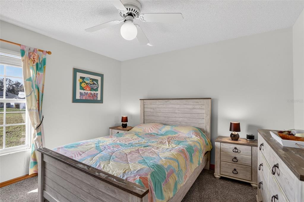 4995 Brook Road Kissimmee, FL 34758 - Photo 20 of 46 a bedroom with a bed and a chandelier