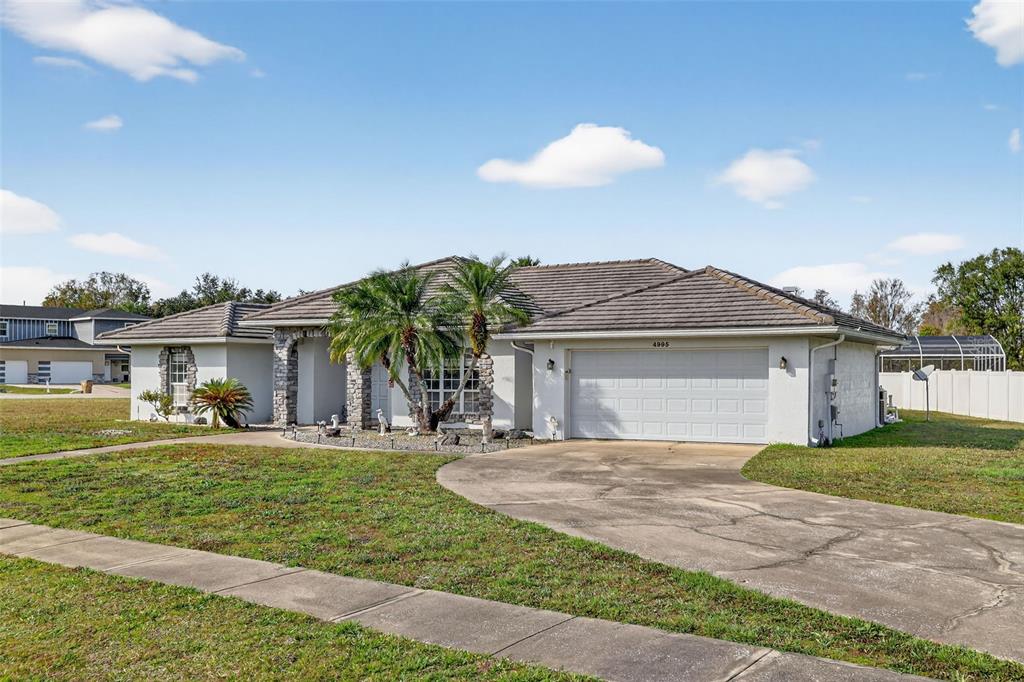 4995 Brook Road Kissimmee, FL 34758 - Photo 2 of 46 a view of a house with a yard and potted plants