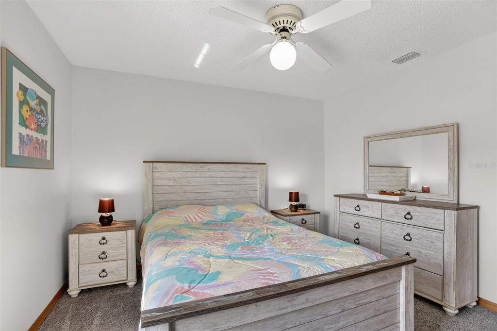 4995 Brook Road Kissimmee, FL 34758 - Photo 21 of 46 a bedroom with a bed and a chandelier