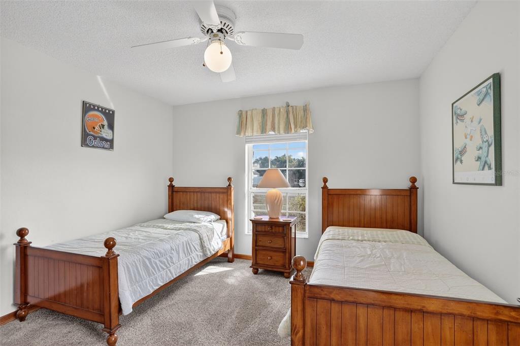 4995 Brook Road Kissimmee, FL 34758 - Photo 23 of 46 a bedroom with a bed and wooden floor
