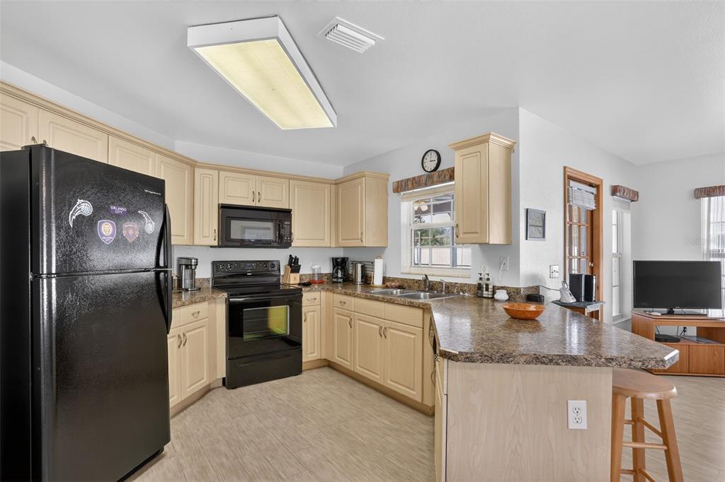 4995 Brook Road Kissimmee, FL 34758 - Photo 10 of 46 a kitchen with a sink stove and refrigerator