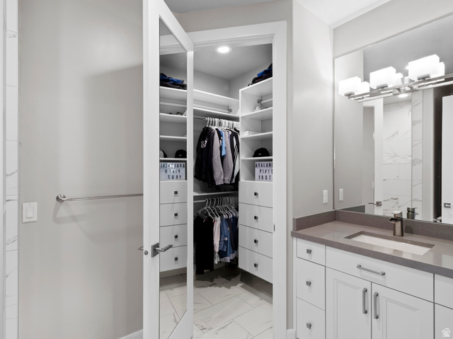 614 East High Lane Alpine, UT 84004 - Photo 56 of 75 Bathroom with light marble finish flooring, vanity, and a spacious closet