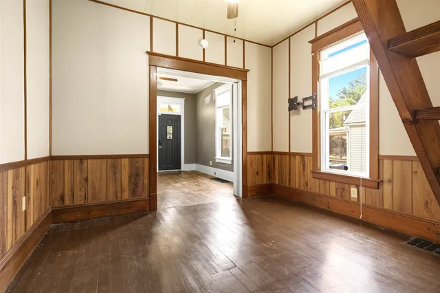 wooden floor in an empty room with a window