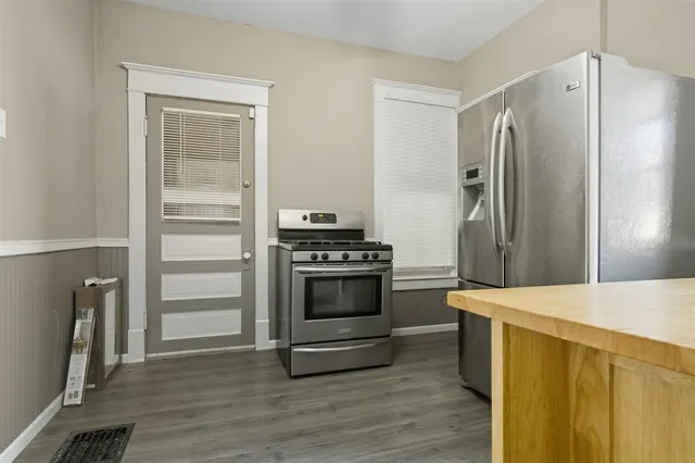 a kitchen with stainless steel appliances a refrigerator and a window